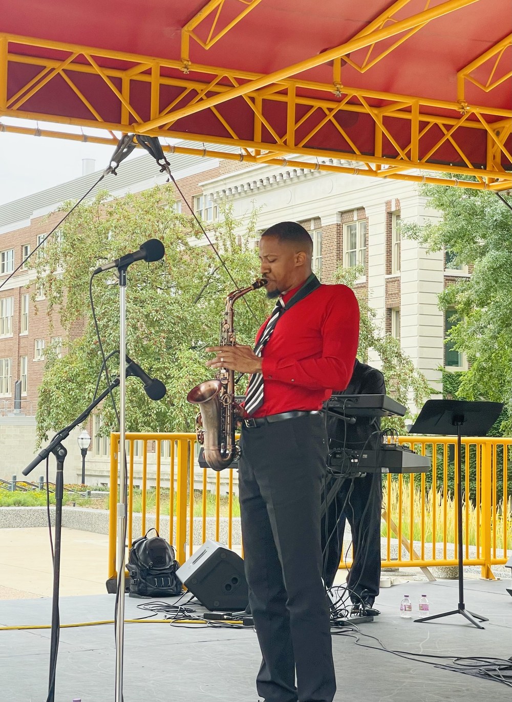 Performing saxophone on an outdoor worship stage